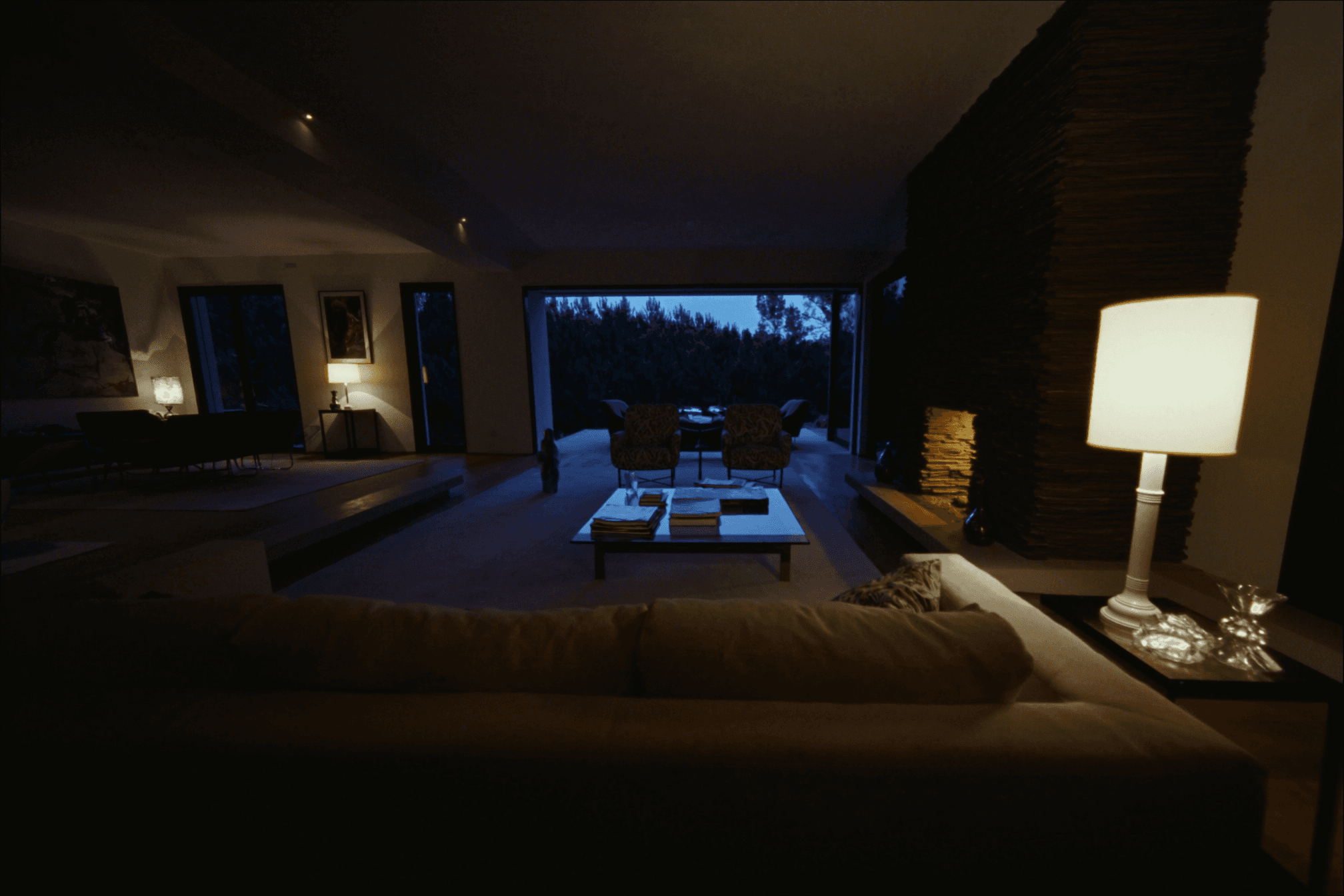 A beautifully staged modern living room glowing at twilight
